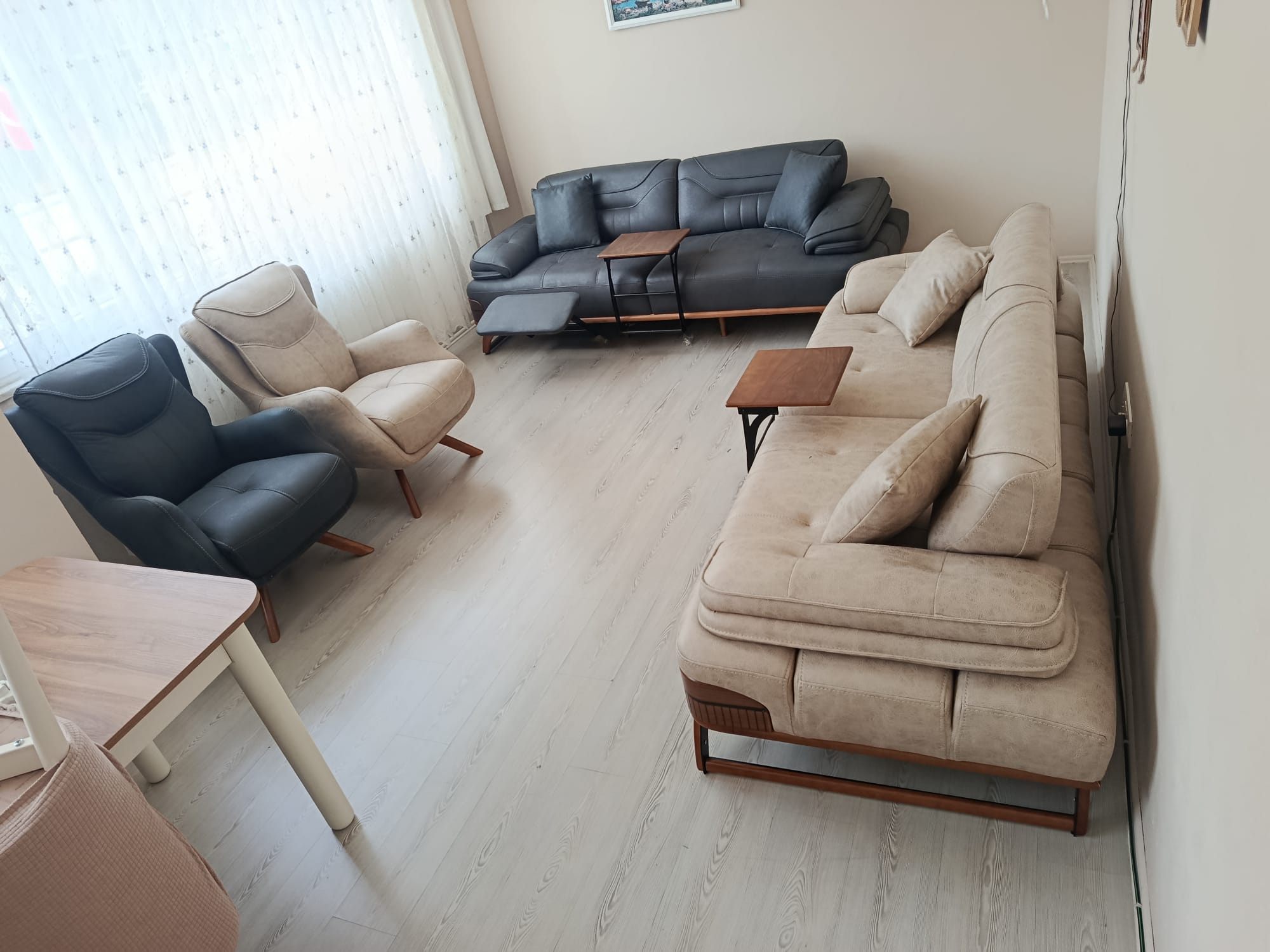 Davut B. 2026 modern Inegol furniture living room set with gray three-seater sofa, beige three-seater sofa, and armchairs.