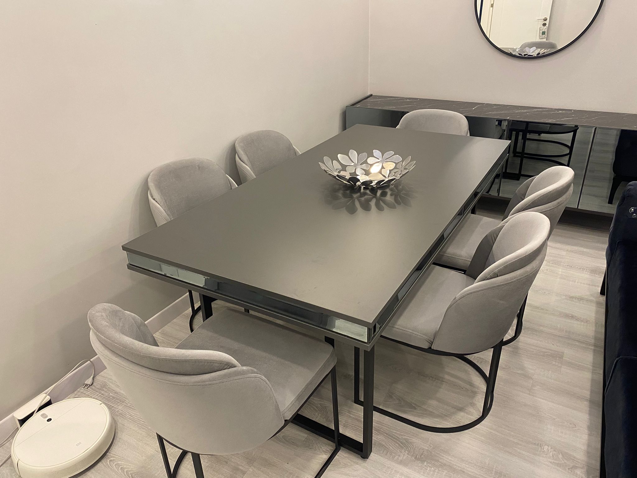 Modern gray dining set featuring a sleek table and six velvet chairs. Offers style and comfort. Affordable Inegol furniture quality.