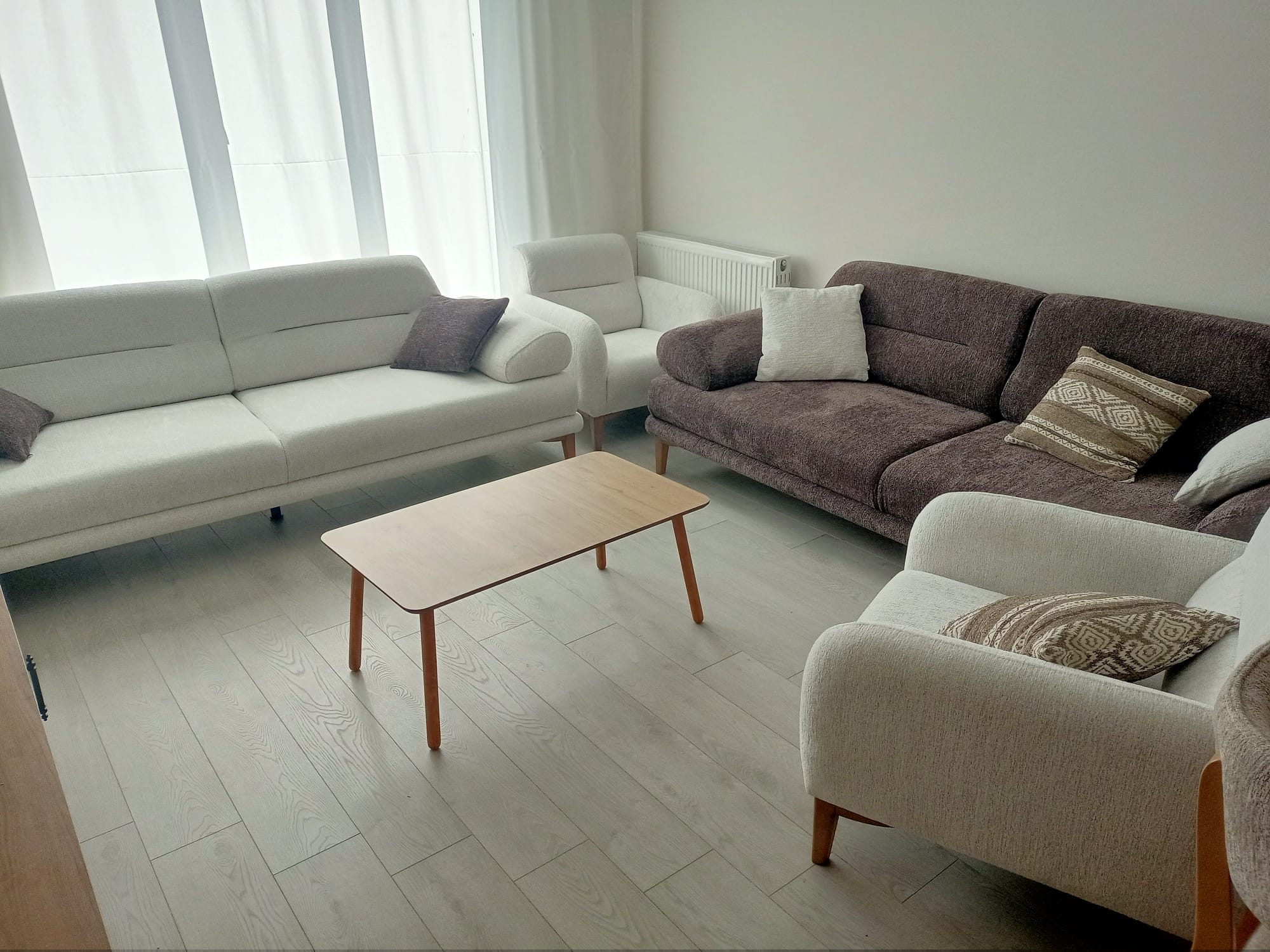 Modern and elegant Abdullah Y. 2026 living room set with light and brown sofas, a wooden coffee table, Affordable Inegol furniture.