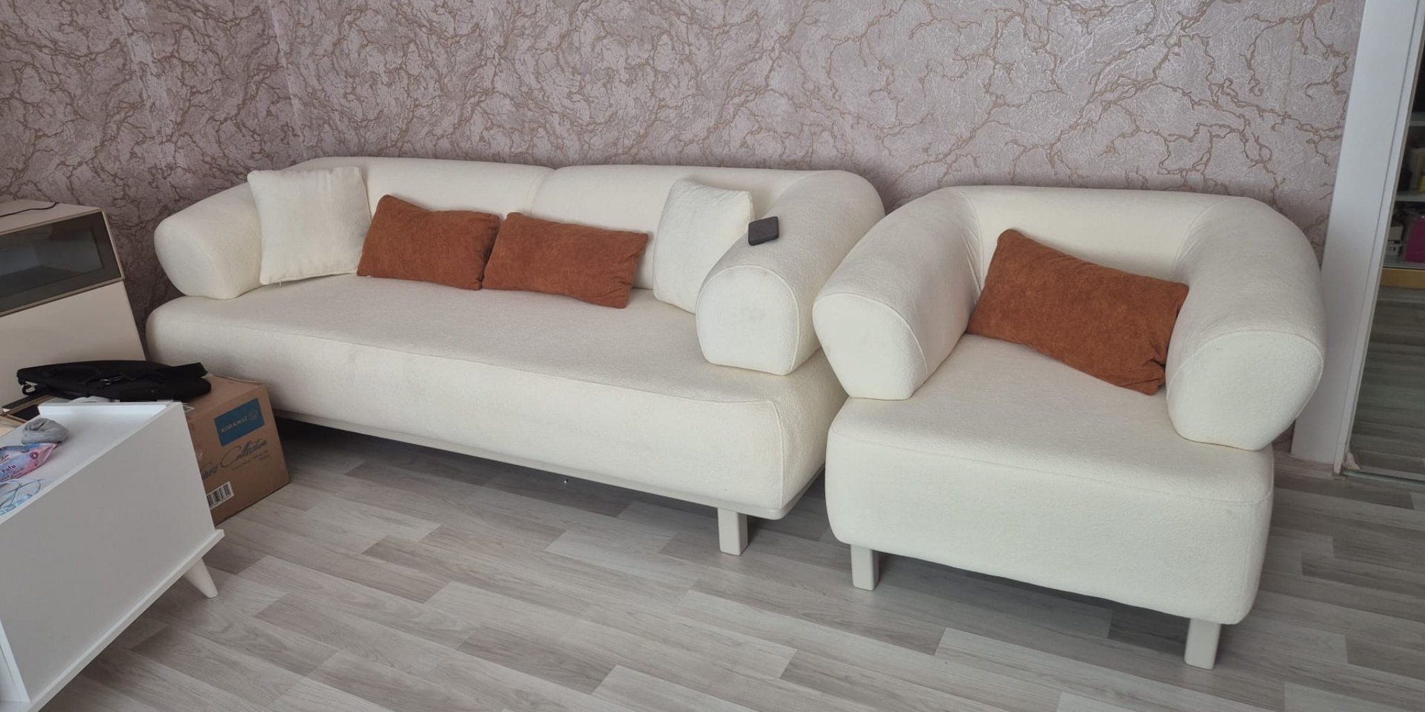 Elegant cream modern sectional sofa set, featuring rounded arms and brown accent pillows, adding style to any living room. Quality Inegol furniture craftsmanship.
