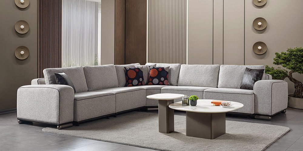 A contemporary grey fabric Sara corner sofa set with black piping details, offering comfort and style. A prime example of high-quality İnegöl furniture.