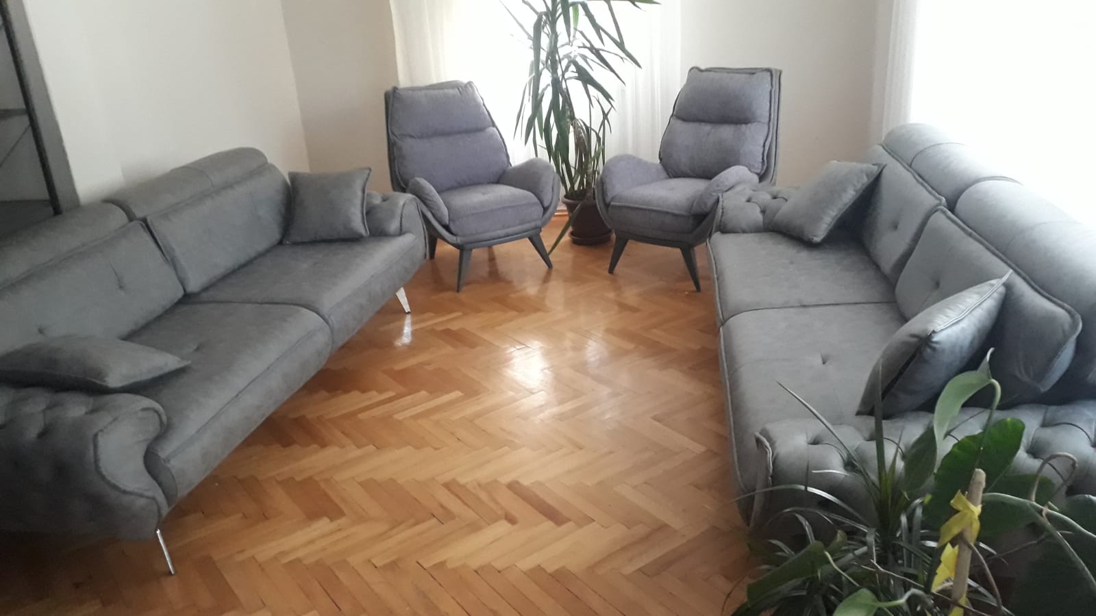 Modern grey sofa set with two sofas and two armchairs, creating an elegant living room. Discover competitive Inegol furniture prices.