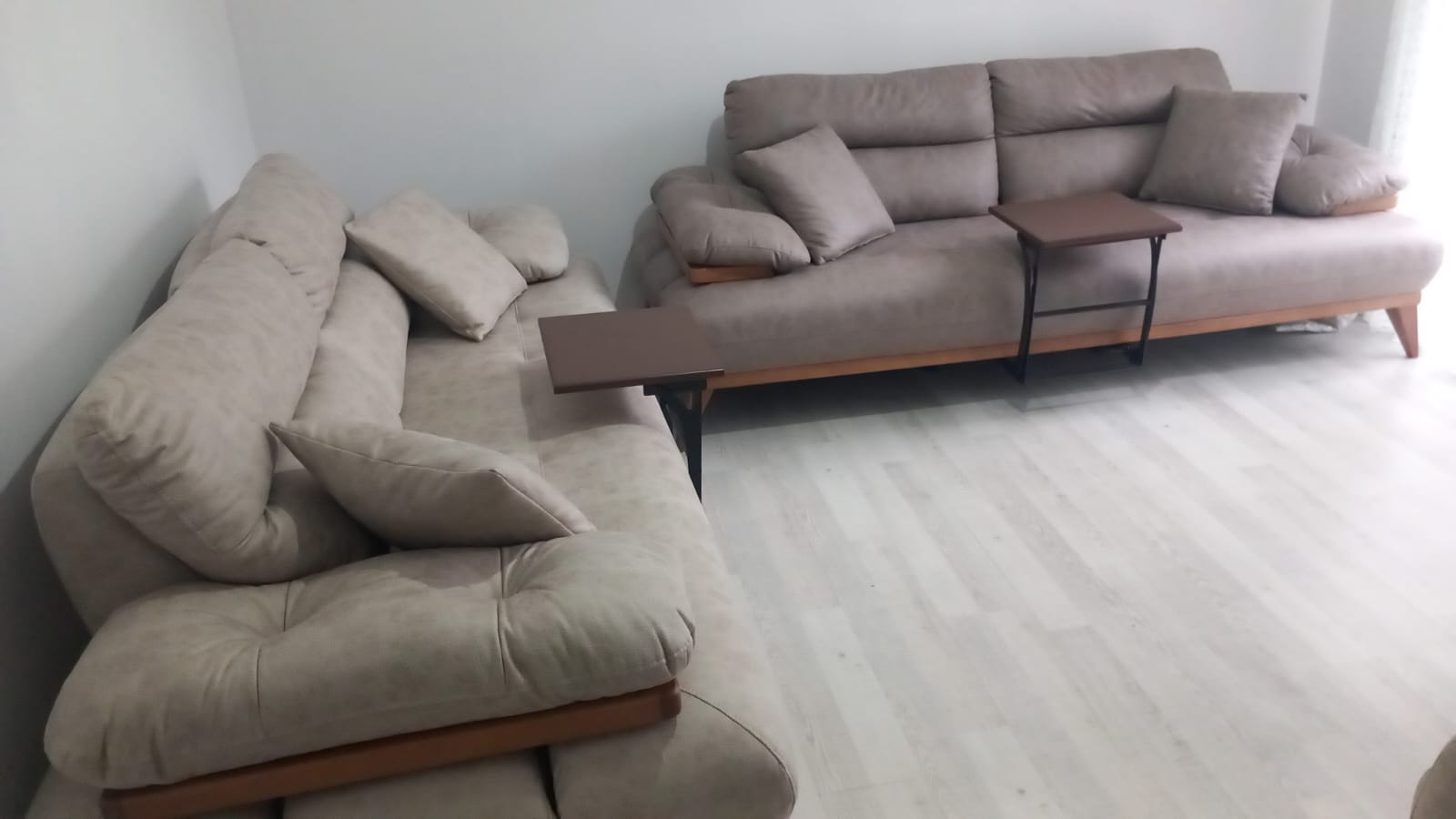 Light beige modern sofa set with wooden accents. This comfortable and stylish Inegol furniture piece blends seamlessly into any home.