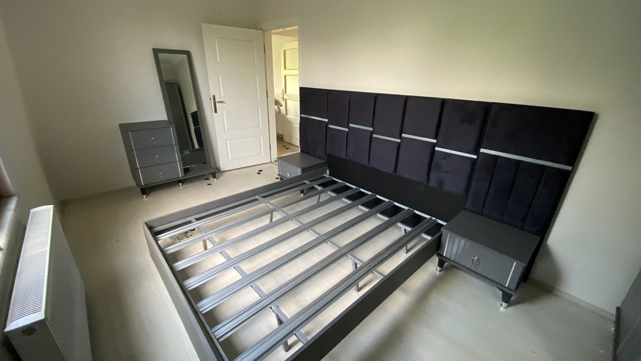 Dark grey modern bedroom set: upholstered headboard, bed frame, nightstands, dresser with mirror. Explore Inegöl Furniture Campaigns.