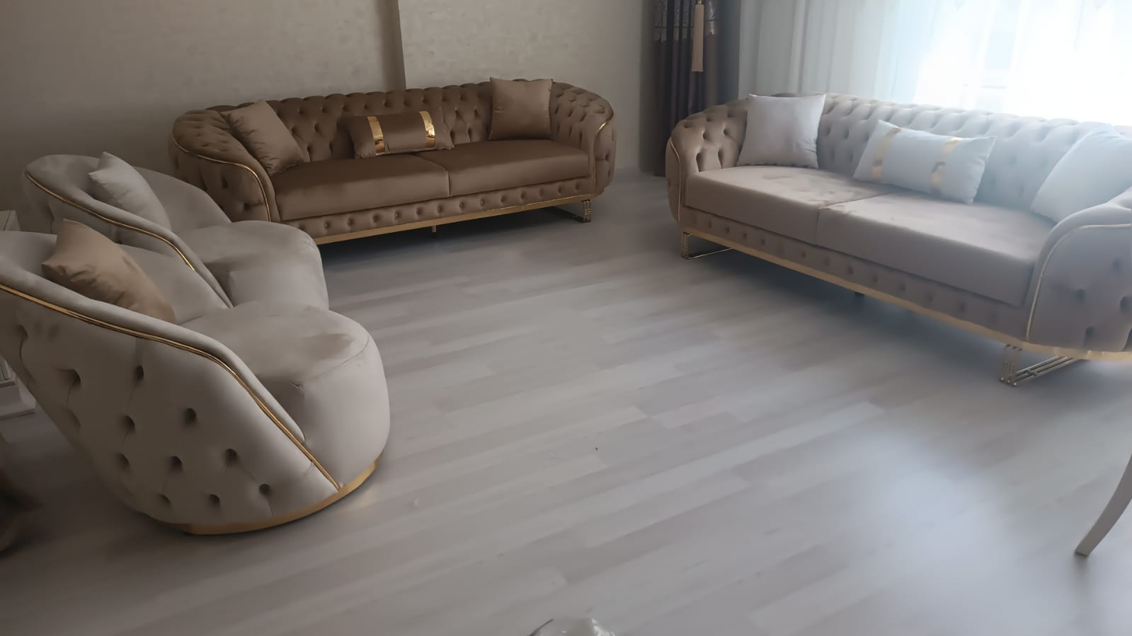 Elegant beige velvet sofa set featuring tufted upholstery and golden trim details, comprising two sofas and an armchair, reflecting Bursa furniture quality.