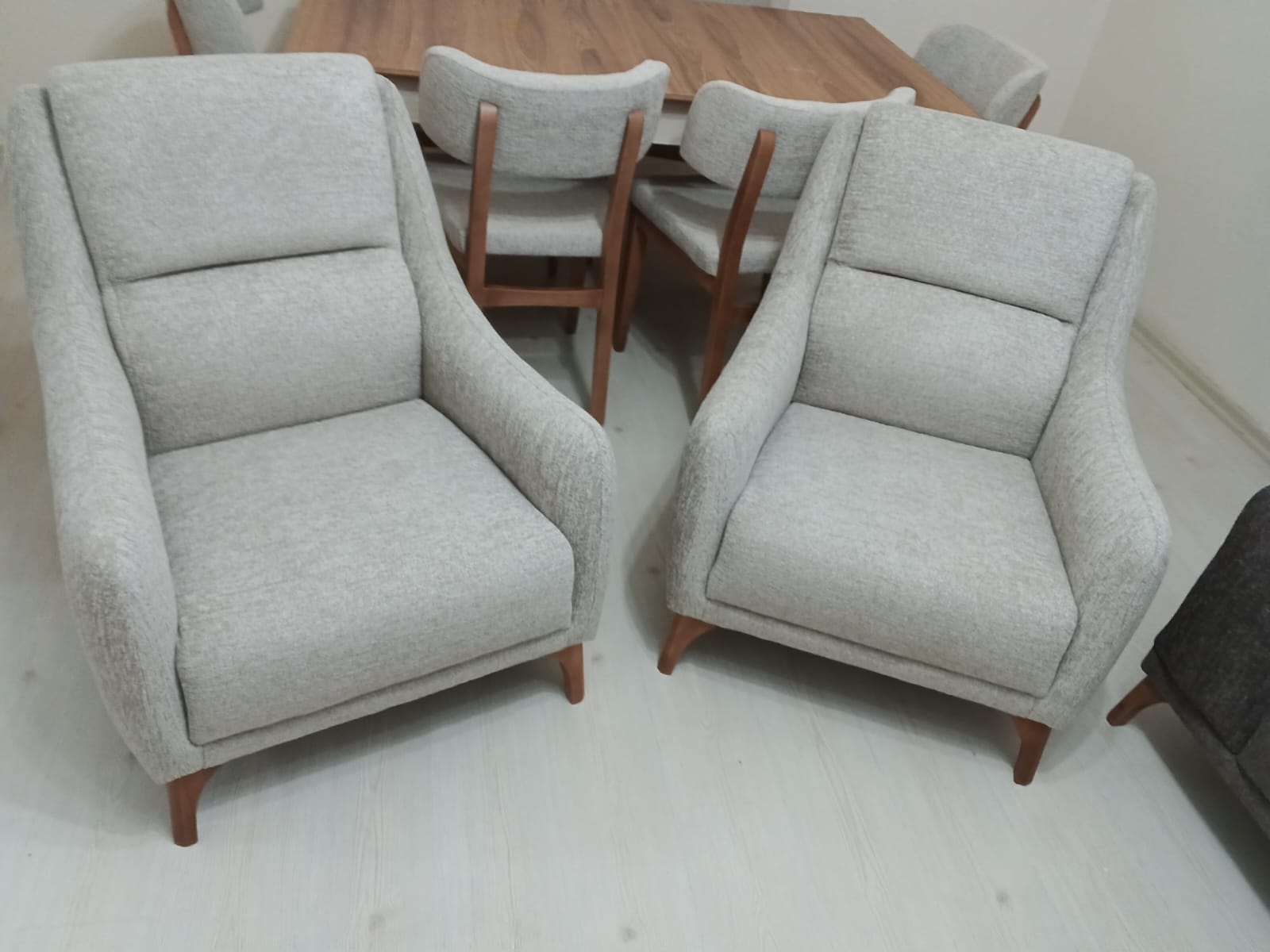 Modern light grey armchairs and a wooden dining set. Add elegance to your home with our Affordable Inegol Furniture collection.