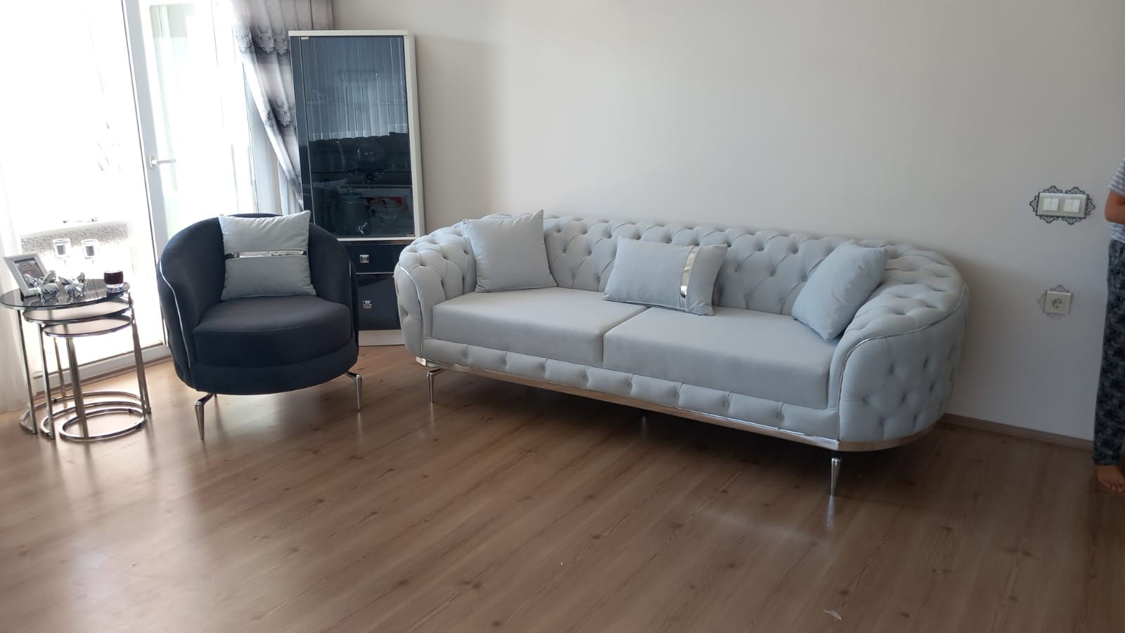 Stylish chrome-legged modern chesterfield living room set. Light gray three-seater sofa and dark gray armchair with silver accents. Best Inegol furniture Prices.