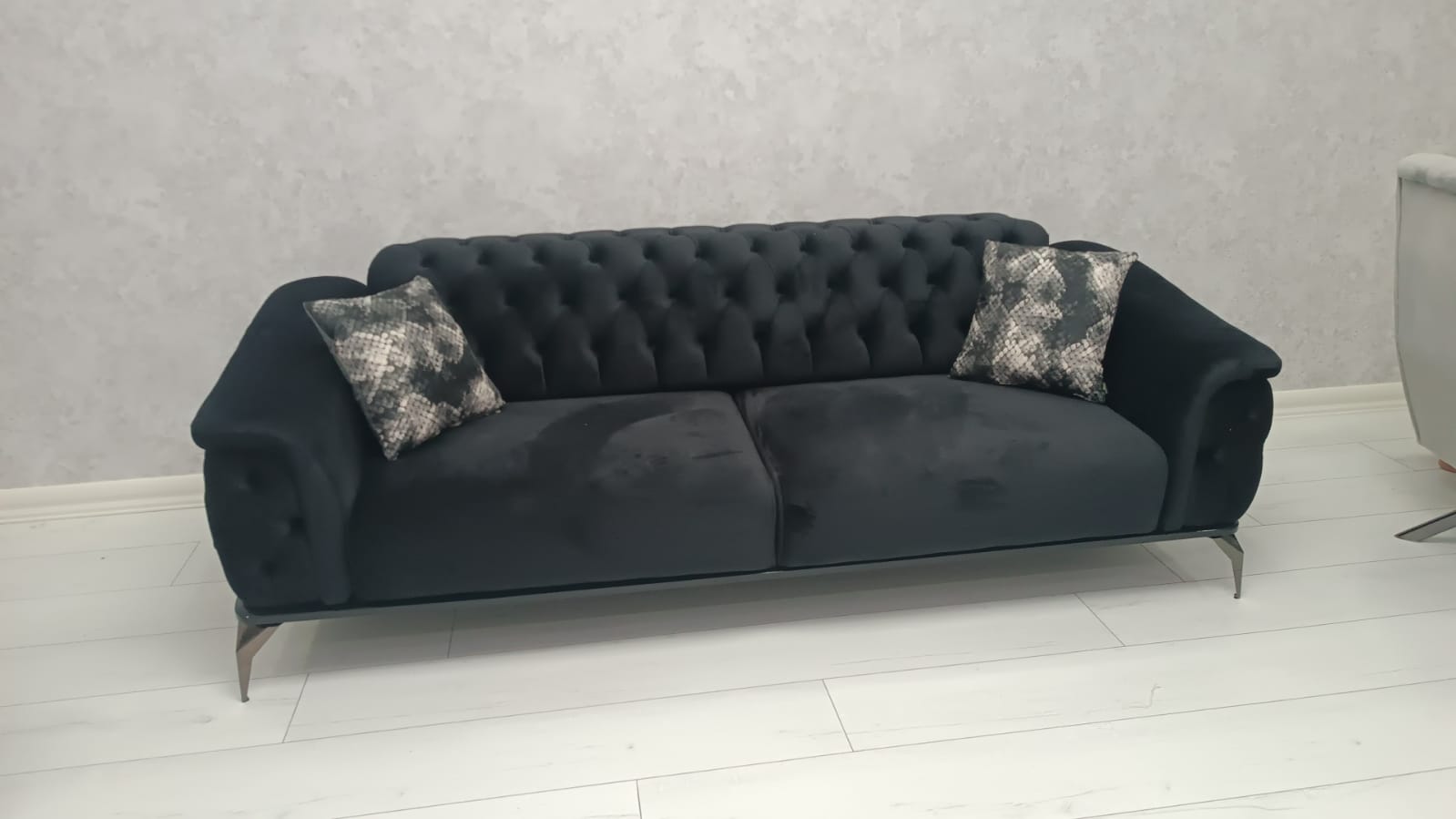 Stylish black chesterfield sofa, adding elegance to living rooms. Discover great inegol furniture campaigns today!