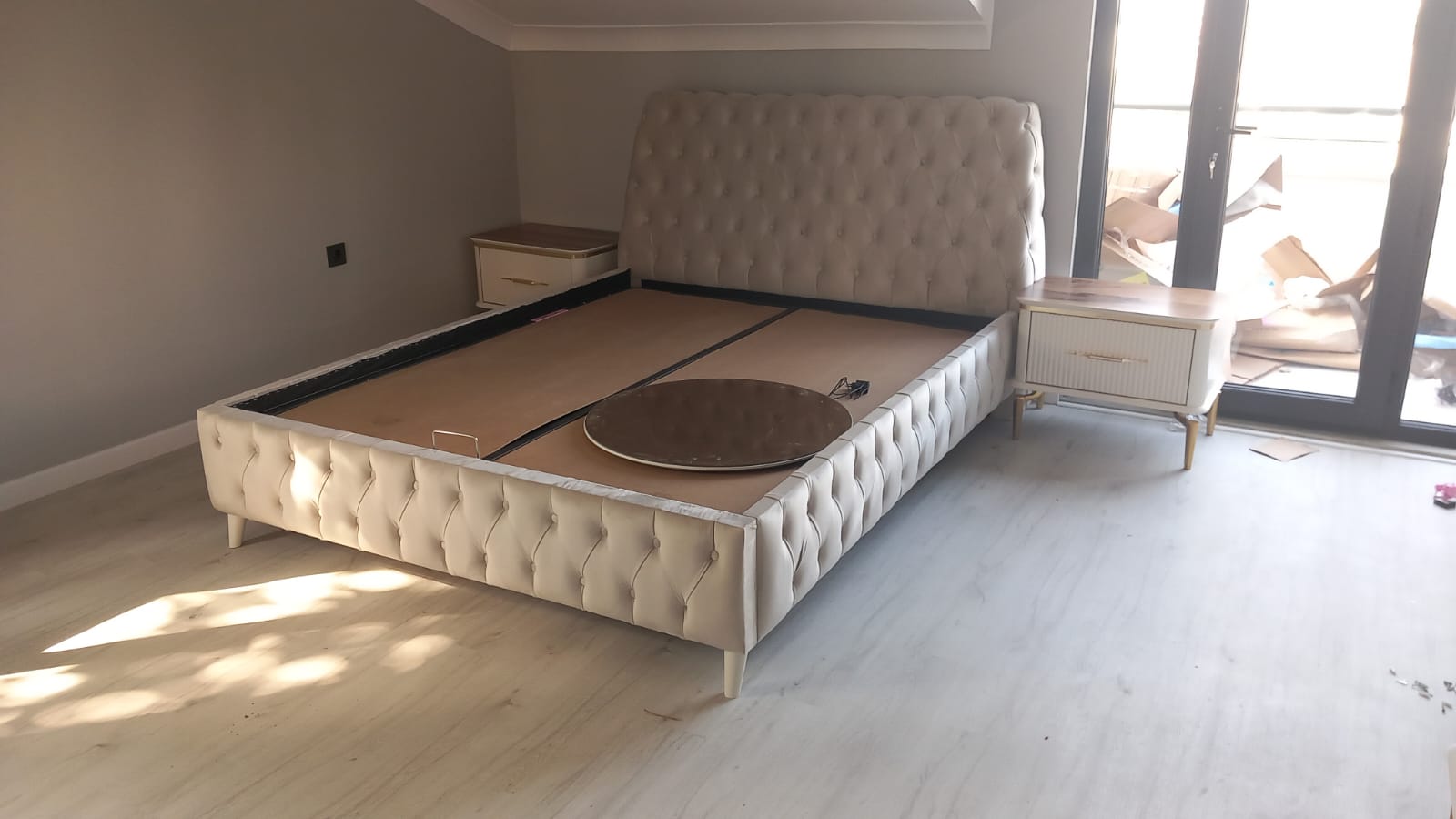 Elegant cream tufted bed frame with matching nightstands, reflecting the quality and style of Inegol furniture.