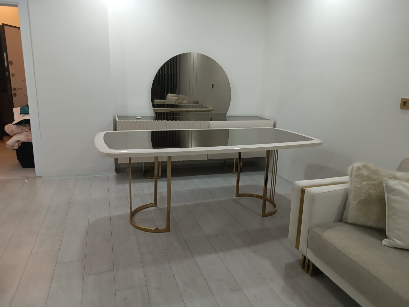 Luxurious modern dining table with a mirrored top and gold accents, complemented by a matching buffet, showcasing quality Inegol furniture.