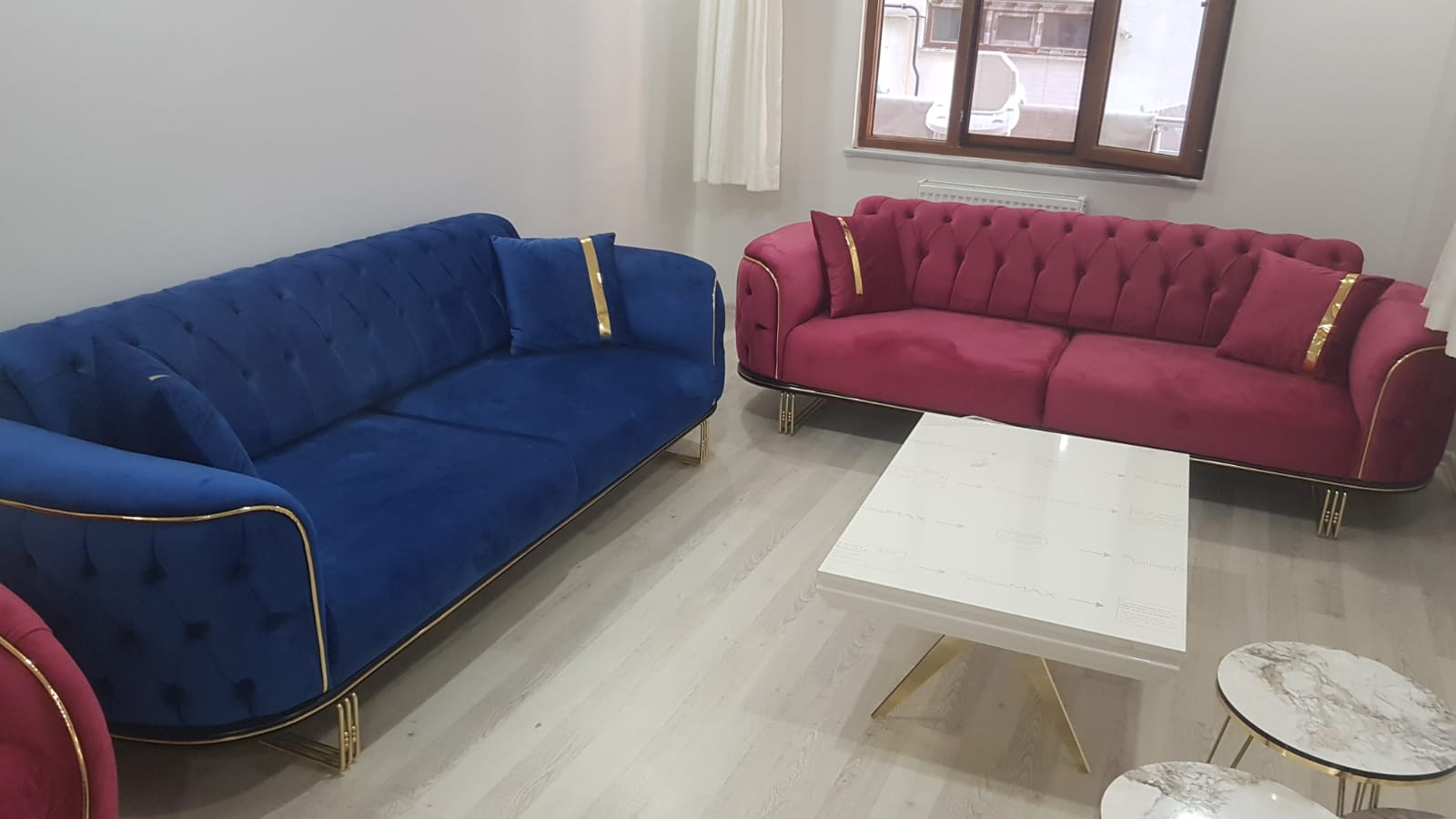 Luxurious blue and burgundy velvet Chesterfield sofa set, featuring elegant gold trim and legs. Perfect for modern interiors, available through Inegol furniture campaigns.
