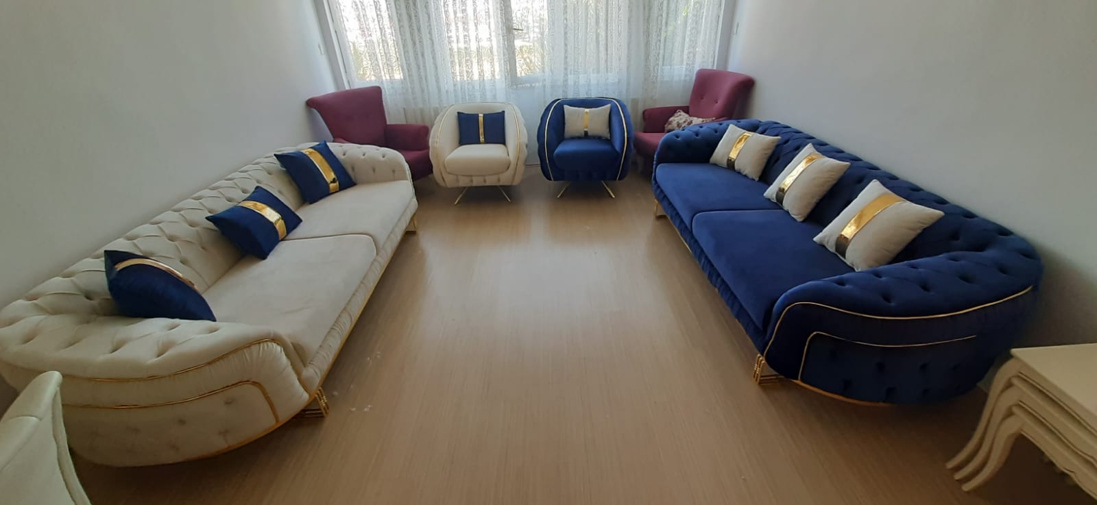 Elegant navy blue and cream velvet Chesterfield sofa set with gold accents. Modern design offering comfort and the quality of Affordable Inegol furniture.