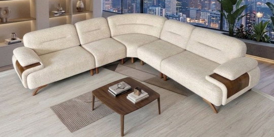 Modern krem rengi Petra Köşe Koltuk Takımı, kavisli formu, ahşap detaylı kolçakları ve şık ayaklarıyla öne çıkar. Kaliteli İnegöl mobilyası.