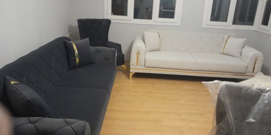 Modern living room set: dark gray and cream sofas with gold accents. Hakan Altınok - Adana collection's elegant modern Inegol furniture.